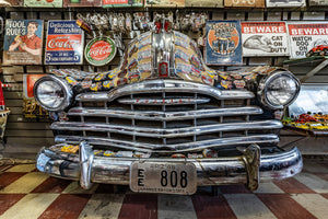 Classic car grill display with Route 66 stickers