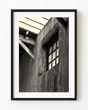 Old prison window and weathered walls in black and white