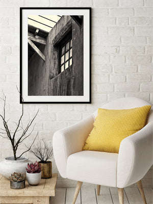 Weathered masonry and dark window framing seen from below