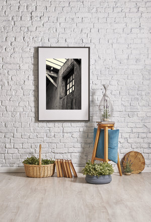 Old prison wall textures beneath a bright open roof