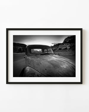 Old truck hood and cracked rear window in black and white
