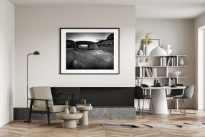 Old roadside truck with rocky hills beyond its windows