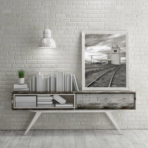 Historic grain elevator amidst Saskatchewan's farming landscape