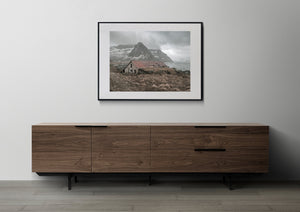 Weathered structure by fjord in soft light