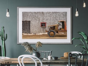 Historic farm vehicle by aged barn structure