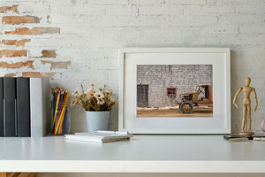 Weathered truck with no doors in farm setting