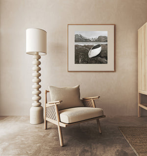 Harmonious scenery with an aged rowboat on calm Norwegian frozen waters 