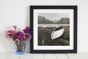 Solitary rowboat on the glass-like waters of Vikvatnet Lake