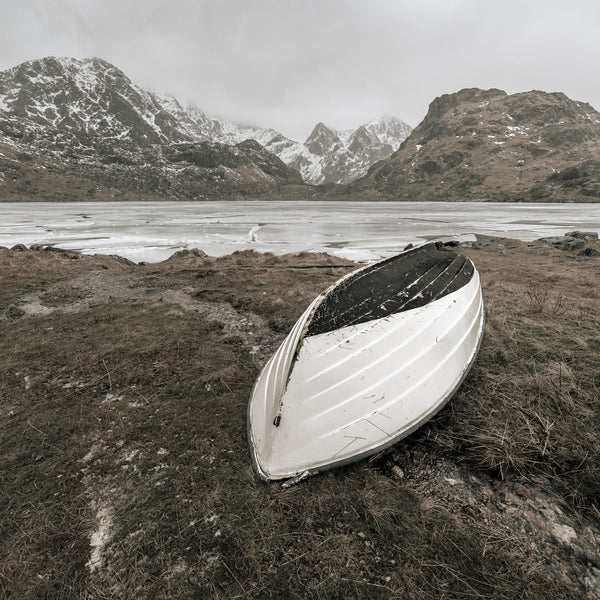 Isolated rowboat on calm waters of Vikvatnet Lake in Norway