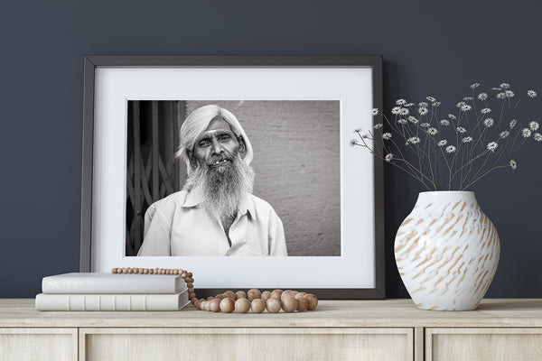 White-bearded man smiling black and white portrait