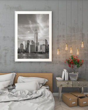 Tall One World Trade Center tower above waterfront buildings
