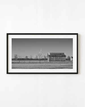 Ontario barn and wind turbines across open fields in black and white