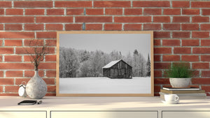 Minimalist winter landscape with barn and falling snow Ontario