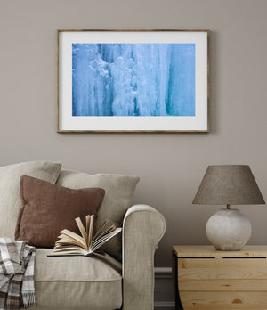 Pale blue ice columns textured with white frost