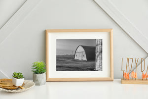 Black and white rural Ontario scene with silo, barn and wind turbines
