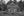 Rustic log farmhouse with split rail fence in rural Ontario black and white