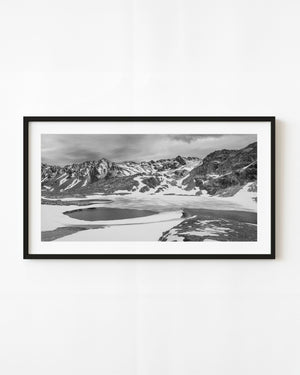 Partly frozen lake beneath snow-covered Martial Mountains near Ushuaia, black and white