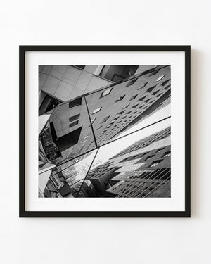 Black and white reflection of modern Oslo buildings in mirrored panels