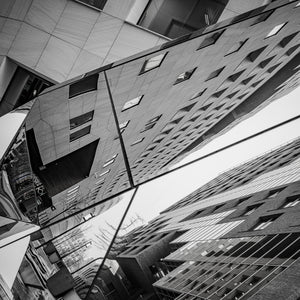 Contemporary architecture reflected in segmented glass facade Oslo