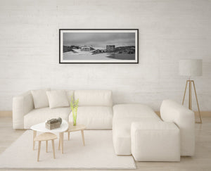 Snow-covered sloping roof of the Oslo Opera House beside harbour ice