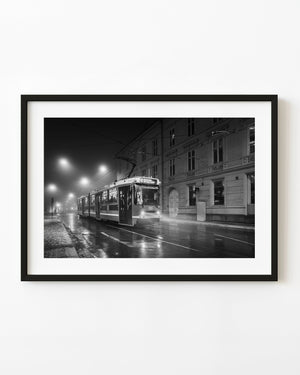 Oslo tram 131 on wet rails beneath foggy street lamps, black and white