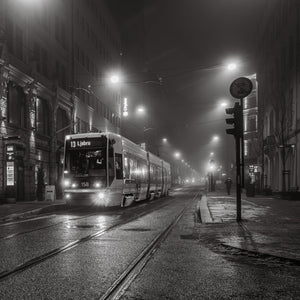Tram 158 on route 13 beside wet rails in foggy Oslo