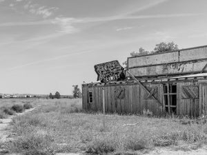 Abandoned wooden restaurant with a faded Outer Limits sign in Nebraska