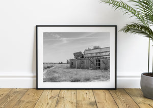 Black and white rural Nebraska scene with a weathered roadside building