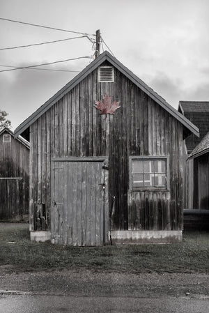 Fishing village building with faded maple leaf in PEI