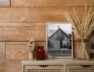 Weathered coastal building with red maple leaf