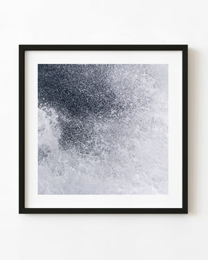 Pacific Ocean spray bursting into droplets in black and white