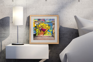 Vivid yellow and orange painted face on a weathered Panama wall