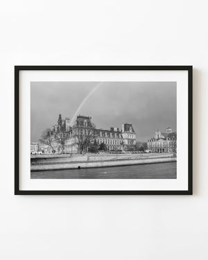 Paris Hôtel de Ville beneath a rainbow beside the Seine, black and white