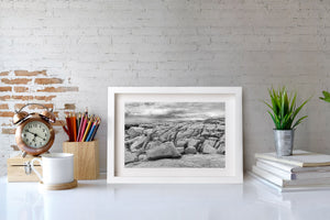 Monochrome Peggy’s Cove shoreline with smooth rock and dark crevices