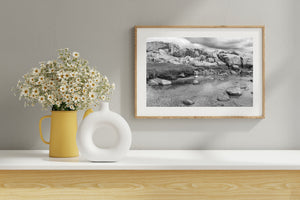Rounded shoreline rocks beneath layered clouds at Peggy’s Cove