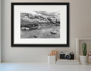 Quiet Nova Scotia tidal inlet surrounded by textured granite slabs