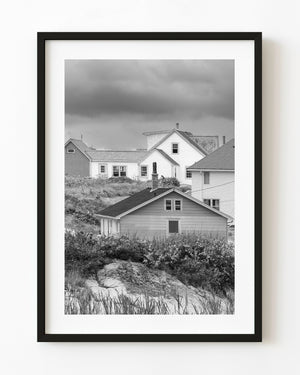 Village homes on a grassy rocky slope at Peggy’s Cove, black and white