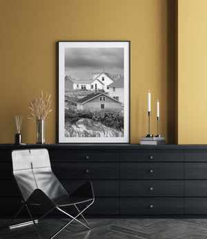 Traditional Peggy’s Cove houses nestled among grass and shoreline rocks
