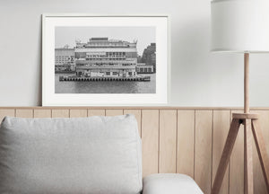 Weathered waterfront building at Pier 57 with rows of windows and large signs
