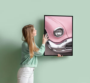 Pink vintage car under afternoon sunlight