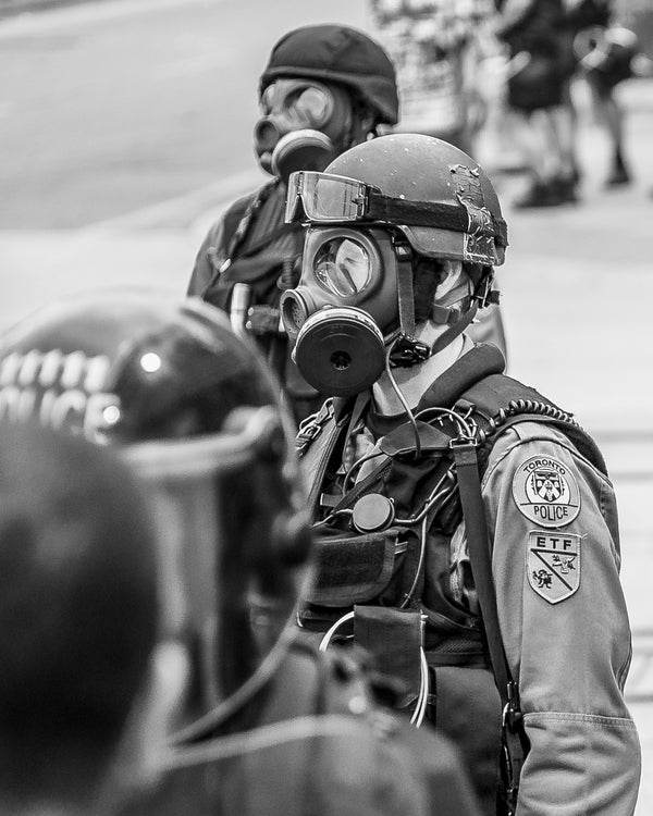 Black-and-white police in riot gear