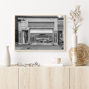 Black and white photograph of a painted service station scene in Pontiac