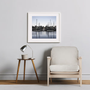 Square colour photograph of sailboats at dawn in Barcelona’s Port Vell