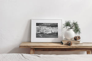 Hand-painted towing warning on a deteriorating waterfront building