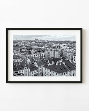 Prague rooftops and Prague Castle in a black and white cityscape