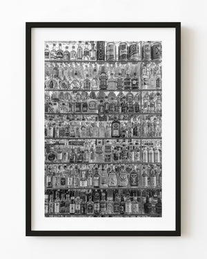 Prague liquor shop window filled with rows of miniature bottles in black and white