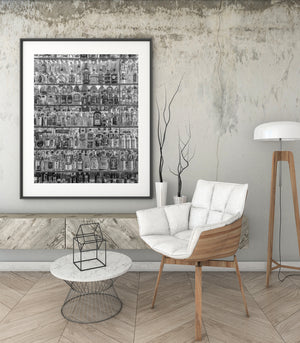 Detailed monochrome view of labels and glass bottles on stacked shelves