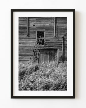Abandoned farm grain elevator ladder on prairie building Saskatchewan