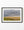 Two combines in a golden prairie field beneath a broad grey sky