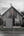 Fishing village building with faded maple leaf in PEI